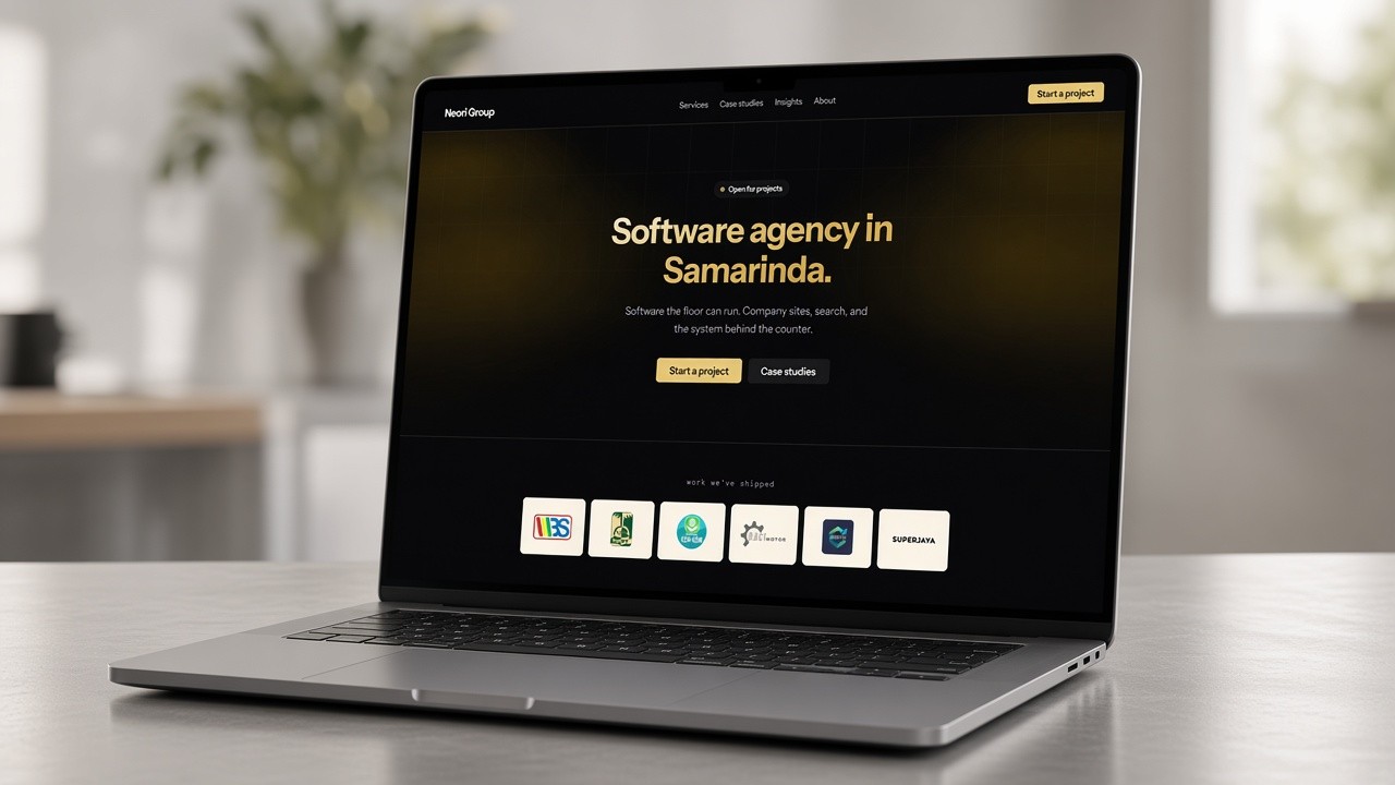 Laptop showing a company profile website on the screen